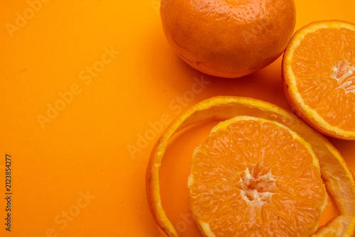 top view of several oranges on a orange background