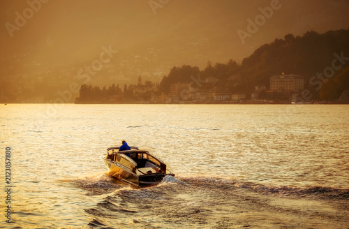 Canvas Print Scenic sunset image of a boat on Lake Como, Lombardy, Italy, Europe