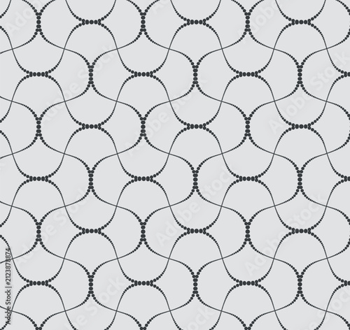 Seamless vector pattern of delicate dotted wavy lines forming an abstract geometric mesh on a gray background. Elegant tile for textile and wallpaper.