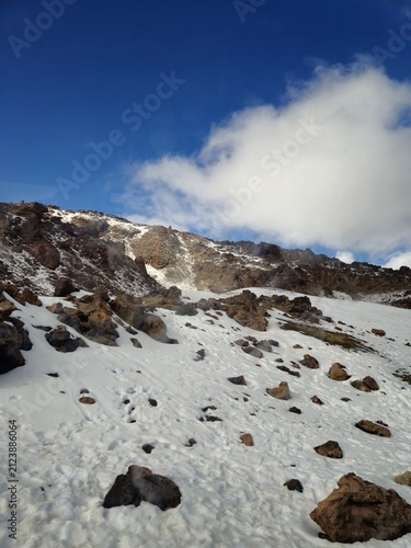 Snow Covered Rocky Mountain Landscape Under Blue Sky
