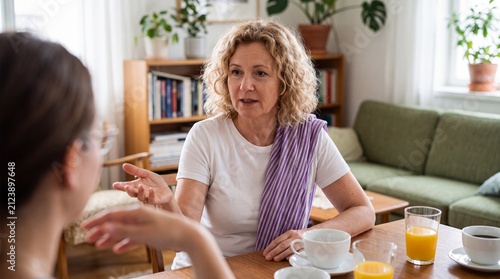 Mature woman having a serious discussion with her daughter at the dining table