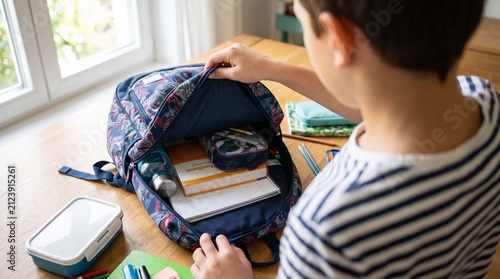 Over the Shoulder View of Packing a School Bag