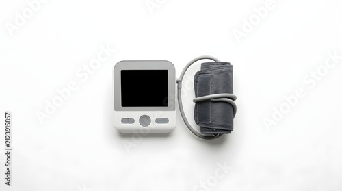 Digital Blood Pressure Monitor and Cuff on White Surface