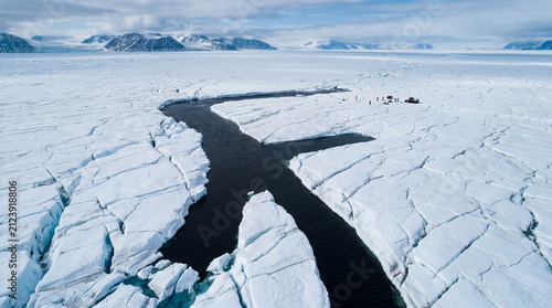 Aerial View of Arctic Glacier Meltwater River in Cracked Ice Fields