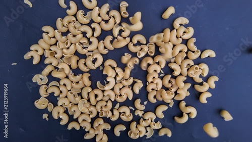 Elbow pasta in kitchen , Slow Motion Italian Kitchen Ingredient Close-Up ,