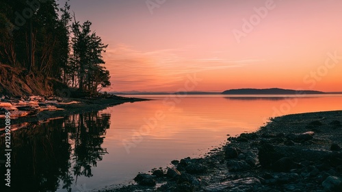 Pastel sky and reflective water over Camano Island coastline at sundown