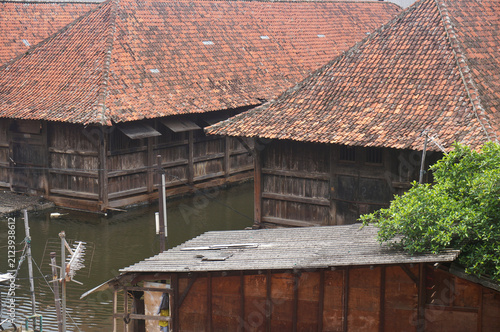 Wooden warehouses are flooded, tiled roofs. Jakarta, Indonesia.