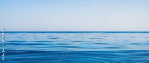 Tranquil Blue Ocean Under Clear Sky Capturing Serenity and Calmness Perfect for Nature, Travel, or Wellness Themes in Stock Photography