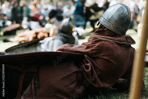 Obraz na plátně Participants in medieval costumes engage in a reenactment of historical battles during a lively festival