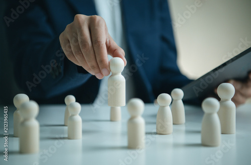 Obraz na plátně Human resources recruitment concept with wooden figures and manager selecting ca