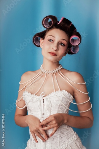Obraz na płótnie Elegance and playfulness blend in a charming portrait with a model in curls agai