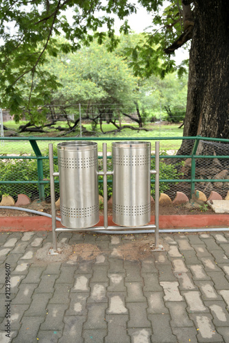 Modern stainless steel dual trash bins in public park promoting clean environment