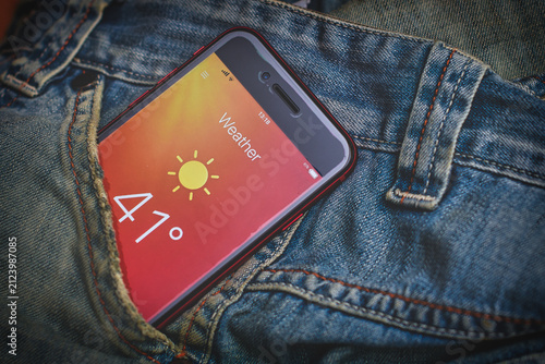 Smartphone Showing Hot Weather Temperature in Denim Pocket