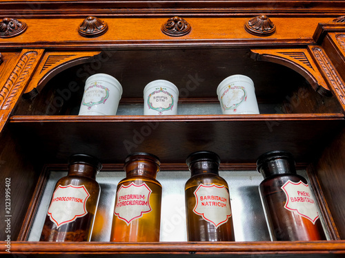 Collection of recipients of chemical substances in an old vintage pharmacy.