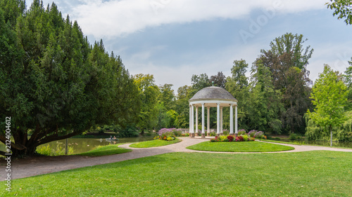 Принти на полотні White pavilion for special occasions, celebrations, and wedding ceremonies in a blooming garden, a round, shaded shelter in the Parc de l'Orangerie in Strasbourg, France