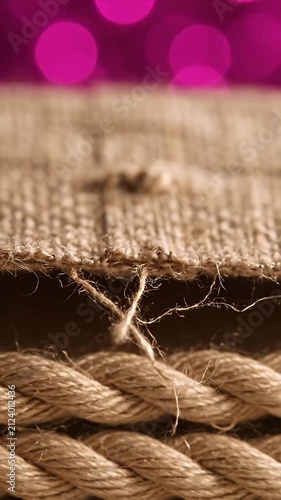 Rustic burlap fabric and braided hemp rope close up.