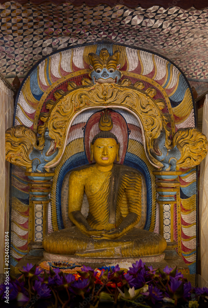 Fototapeta premium Golden Buddha statue inside a traditional Buddhist temple with ornate decorations
