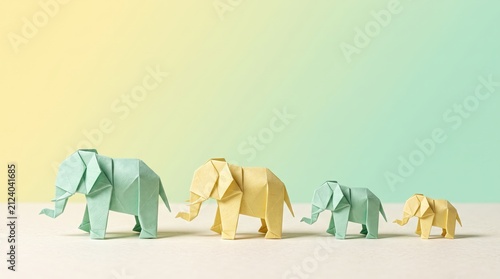 Colorful Origami Elephants in Various Sizes on Soft Gradient Background