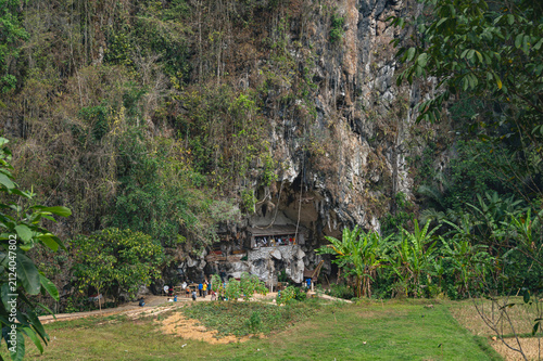Ancient cliff burial site with ancestral coffins in natural rock caves at Londa, North Toraja, South Sulawesi, Indonesia