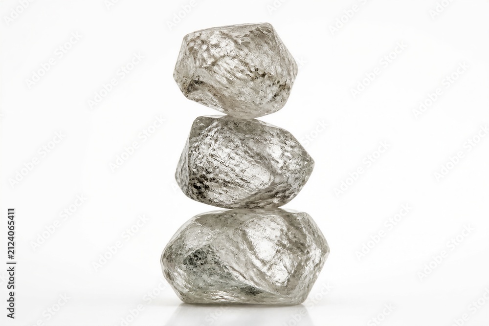 Fototapeta premium Raw rough diamonds stacked in studio on white surface