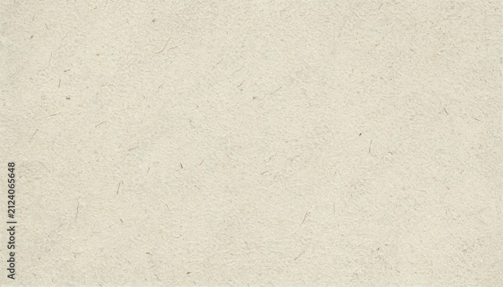 Obraz premium Close up of a light beige textured paper sheet with visible dark fibers scattered across the surface creating an organic and natural appearance