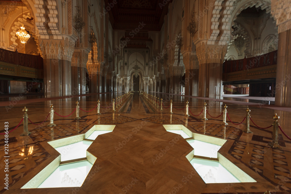 Fototapeta premium Illuminated grand corridor and pools in the interior of the historic mosque in Casablanca, Morocco