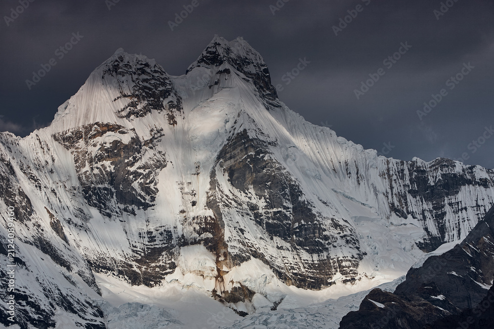 Obraz premium Jirishanca's razor-sharp granite and ice spires pierce a flawless Andean sky in Peru's remote Cordillera Huayhuash, one of the most dramatic and least-visited mountain ranges on Earth. 