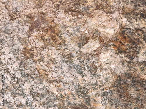 Foto Macro texture of a raw natural stone surface with mineral grains, illustrating g
