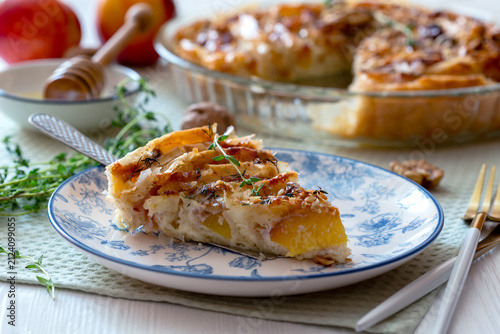 Piece of pie with nectarines and camembert.