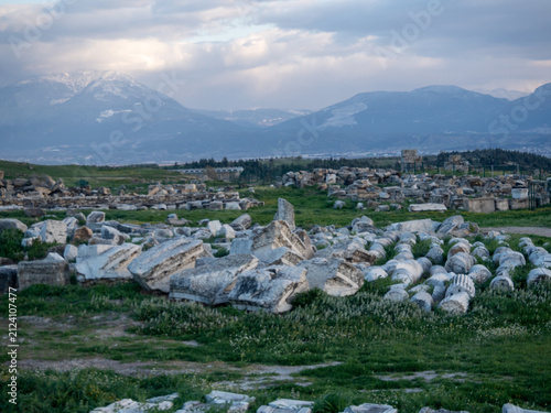 Photography Ancient ruins with mountains in the background.