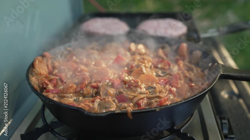 Steaming vegetable stew simmering on a camping stove