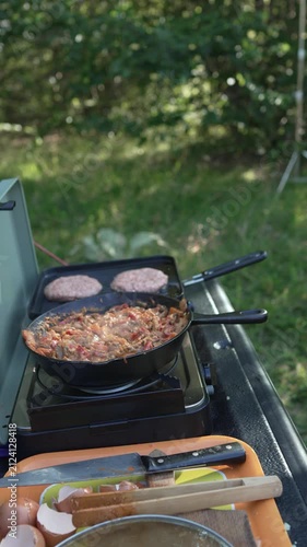 Person cooking breakfast on a portable camping stove