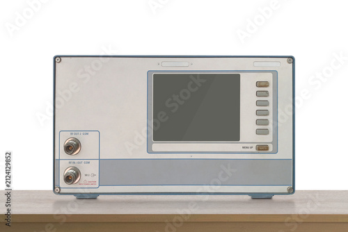 front view old electronic RF (Radio Frequency) signal testing and measuring device resting on a wooden floor, white wall background, object, decor, technology, collection, copy space