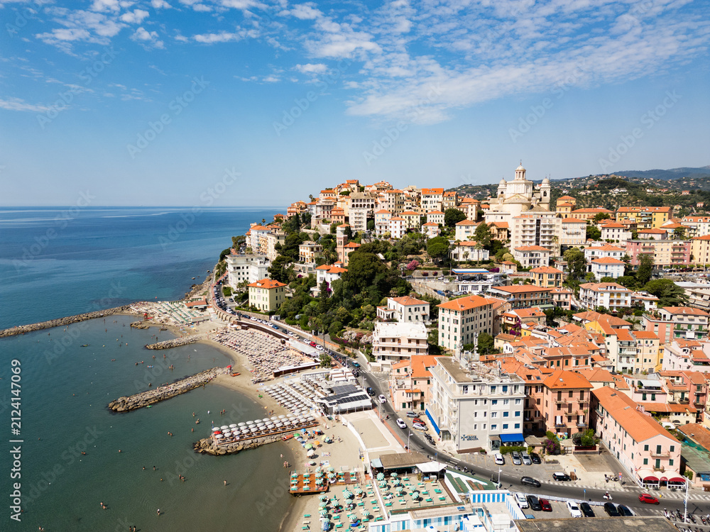 Naklejka premium Aerial panoramic landscape of coastal town Of Imperia in Liguria with sandy beach, marina and historic cathedral on a sunny day