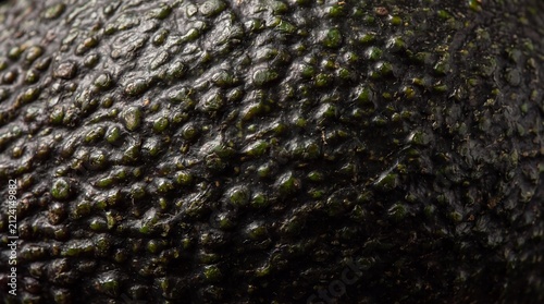 Close-up Texture of an Avocado: An extreme close-up showcases the rough, bumpy, and vibrant green skin of an avocado, highlighting its natural, organic texture and detail.