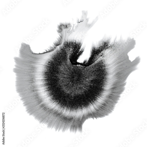 Ink blot with radial chromatography streaks fading to gray on white background