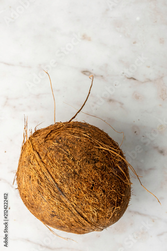 Closeup of coconuts on a white marble surface 