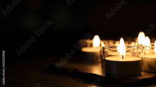 Tea light candles flickering in dark room 4K Video