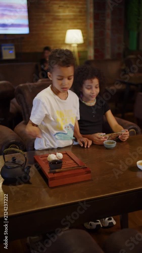 Young boy performing traditional tea ceremony