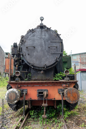 Obraz na płótnie Photograph of an old, decommissioned locomotive at a steelworks site