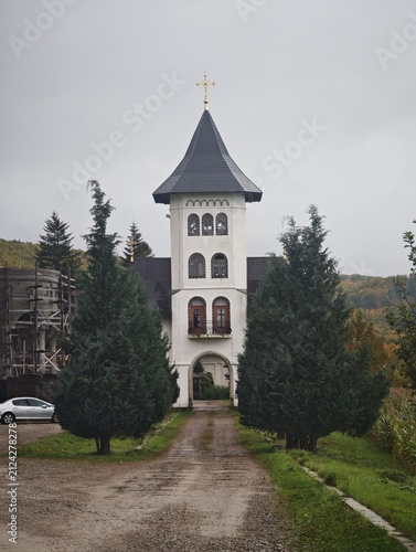 Fotografie White church tower at the end of a path