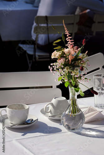 Outdoor event with flowers and coffee cups on the table