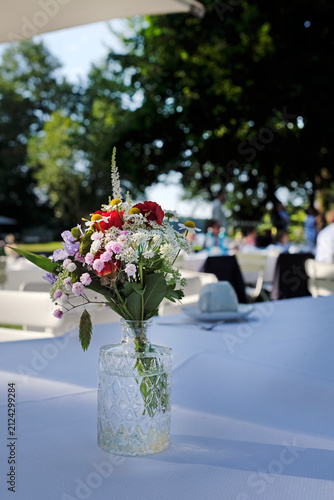 Outdoor event with flowers and coffee cups on the table