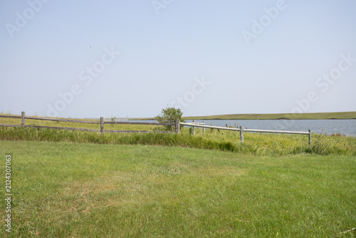Tranquil Waterfront Pasture with Wooden Split Rail Fence