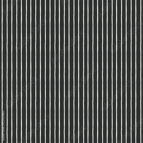Vertical stripe vector seamless pattern. Textured off white painted stripes repeating on a deep charcoal black background. Ideal for dark accent wallpaper, cozy bedding, and Scandinavian decor