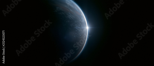 Sunrise over planet Earth viewed from space. Bright sunburst on dark planetary horizon with atmospheric glow, black space background