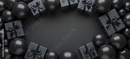 Top view of black gift boxes and christmas ornaments arranged as a frame on a dark background