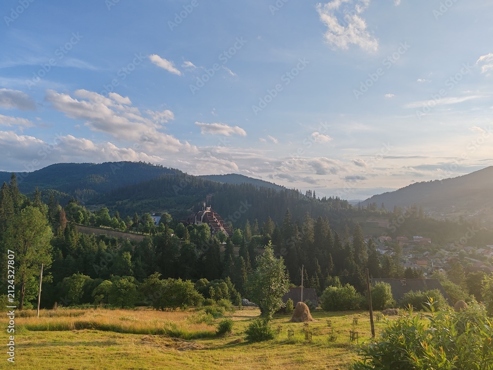 Obraz premium Scenic view of green Carpathian mountains hills covered with forest under cloudy sky