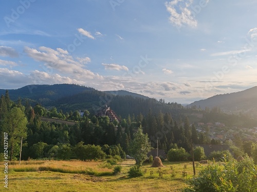 Scenic view of green Carpathian mountains hills covered with forest under cloudy sky