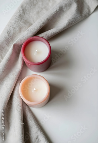 Two lit candles in pink and...